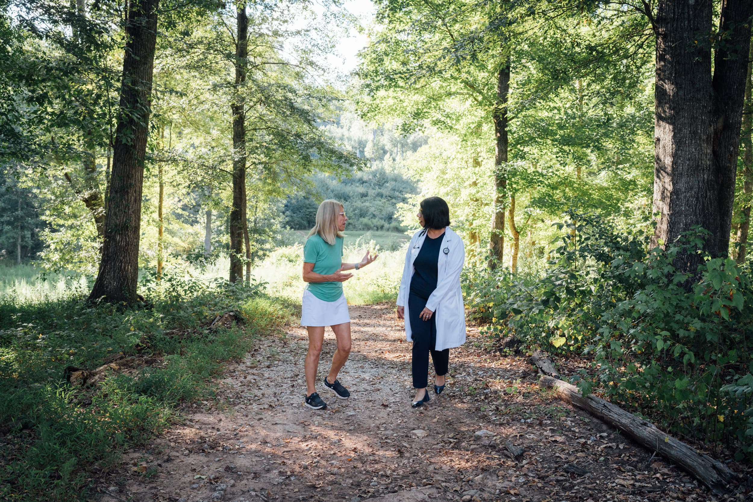 A doctor walking outside with a patient